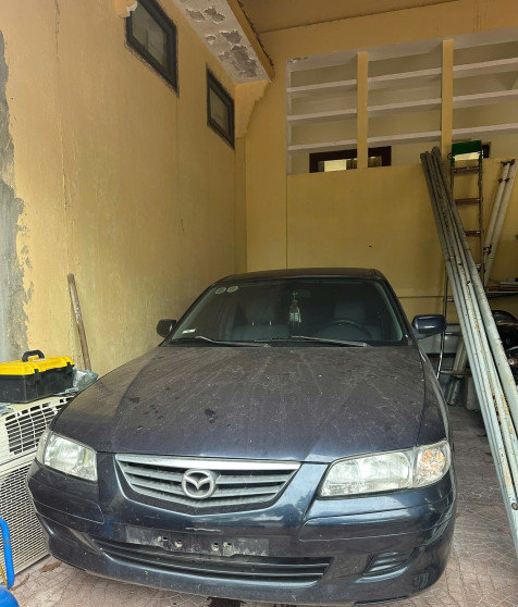 Xe ô tô con mang nhãn hiệu MAZDA 626, màu sơn xanh, mang biển kiểm soát 74A-001.73.